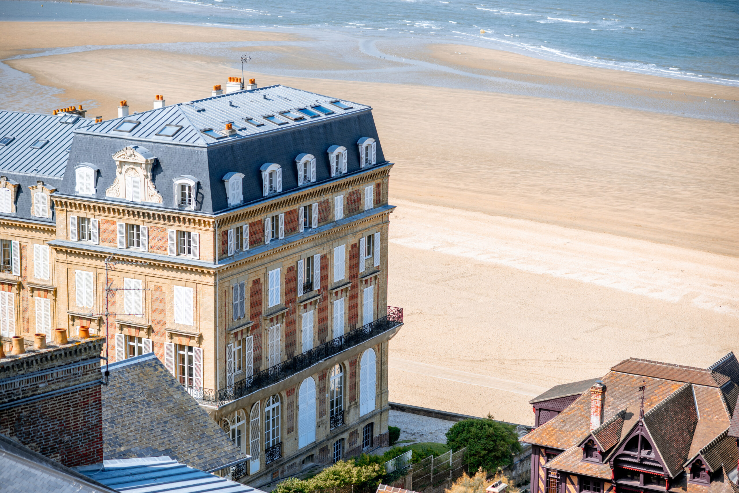 Luxury houses on the coastline with beautiful beach on the background in Trouville, famous french town in Normandy